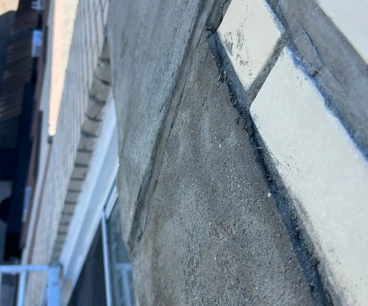 Freshly pointed mortar joints along the brick façade edge at 149-46 41st Ave in Flushing, Queens.