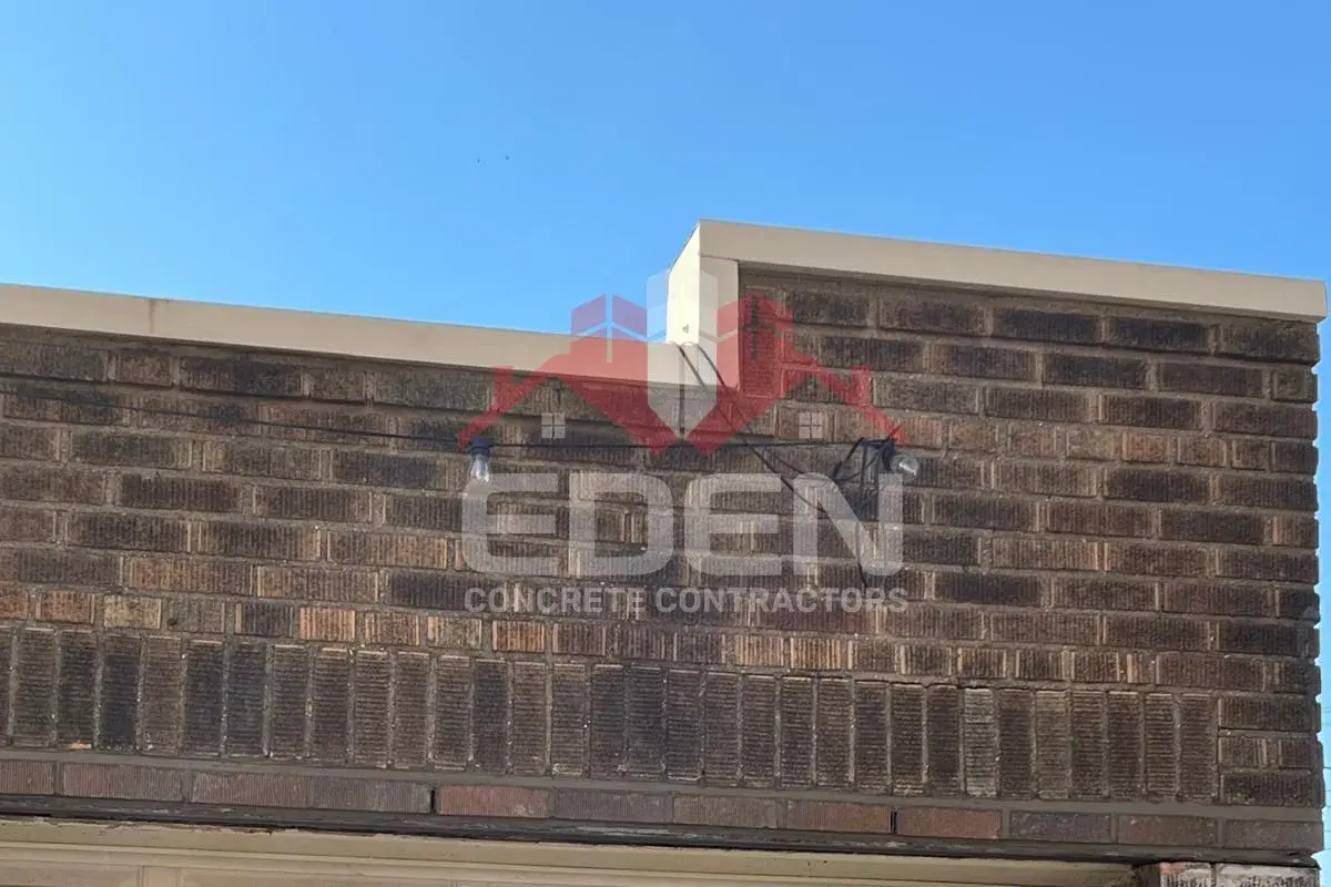 Brick parapet wall on the roof edge of a new york city building providing safety and architectural detail