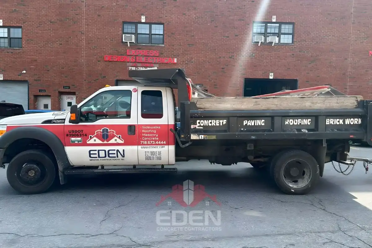 Damaged sidewalk and building exterior in new york city requiring dob emergency repair work.