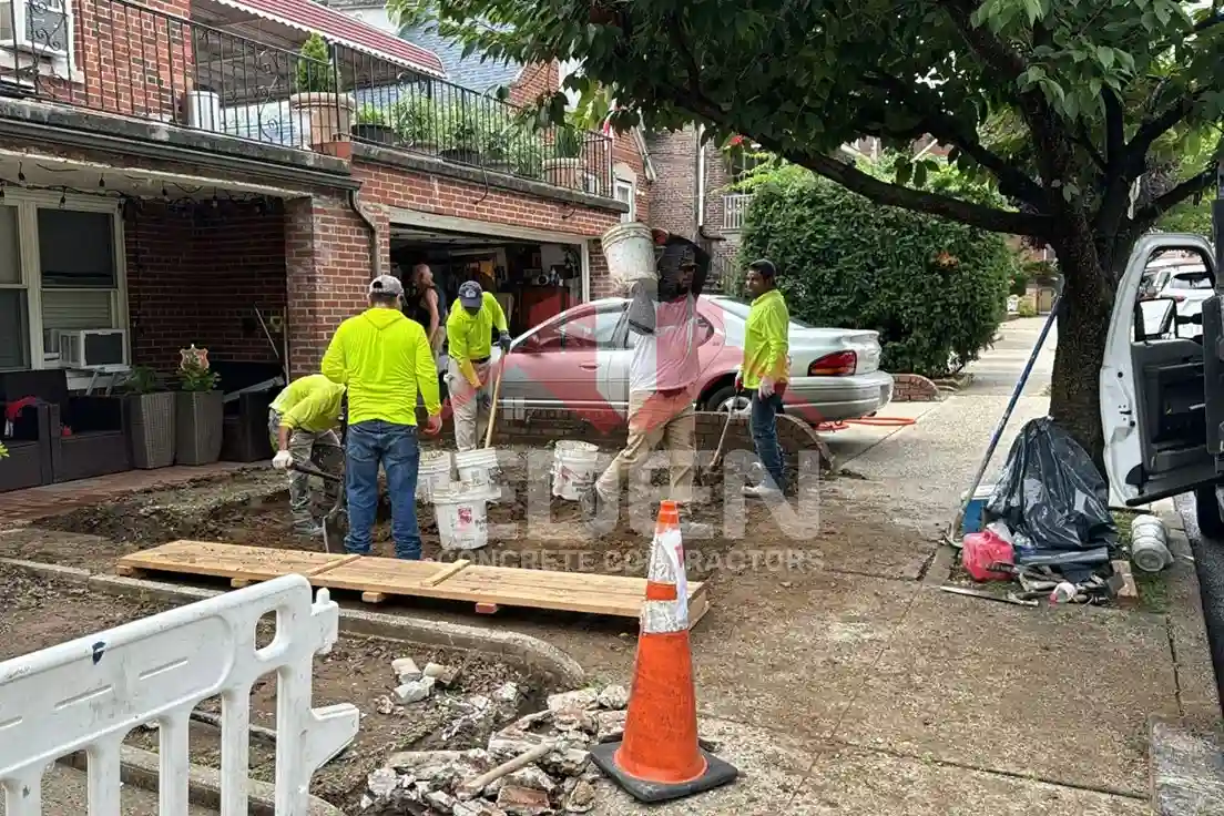 Damaged sidewalk in new york city with cracks and uneven slabs that could lead to a sidewalk violation notice.