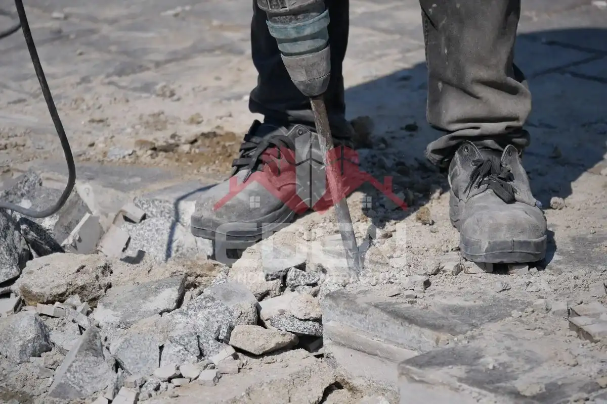 Cracked and uneven sidewalk in new york city indicating the need for sidewalk repair